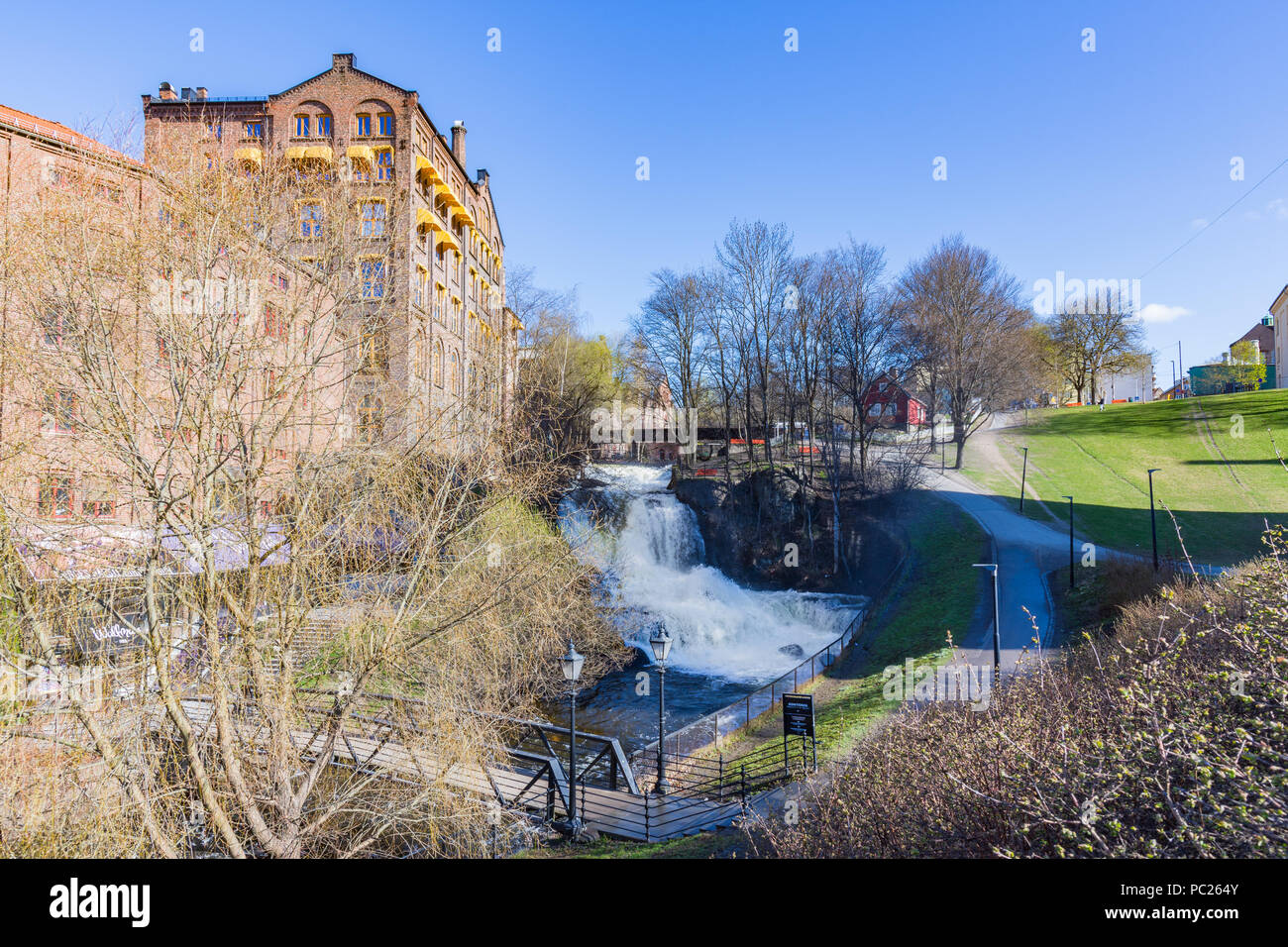 The largest waterfall of the Akerselva River in Oslo is the one near the cottage known as `Hønse-Lovisas hus`, a small red house near the Beier bridge Stock Photo